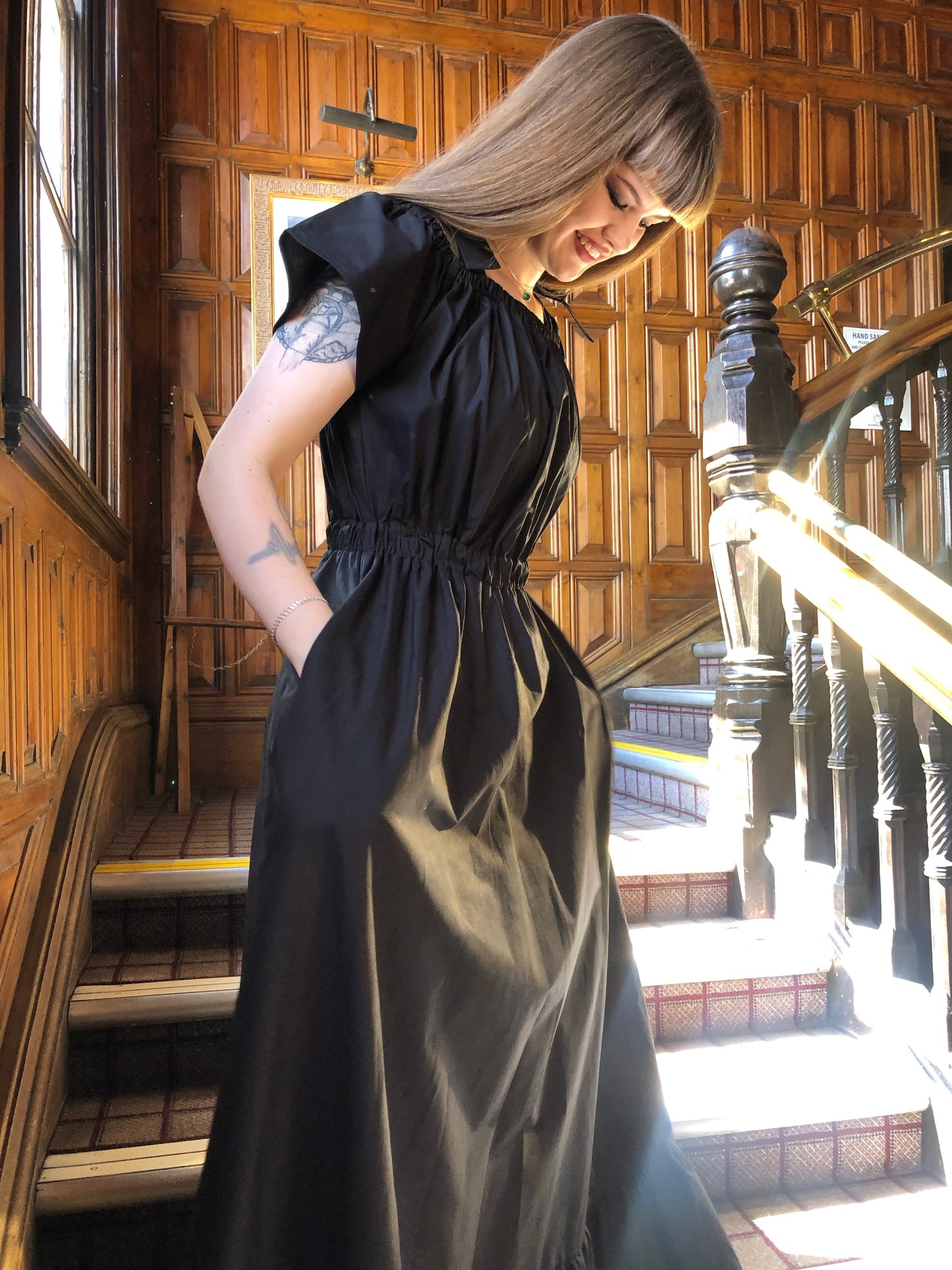 Pictured is the Midaxi Zwina Dress With Pockets in black on our model who is 5"11 and wears a small, with black boots