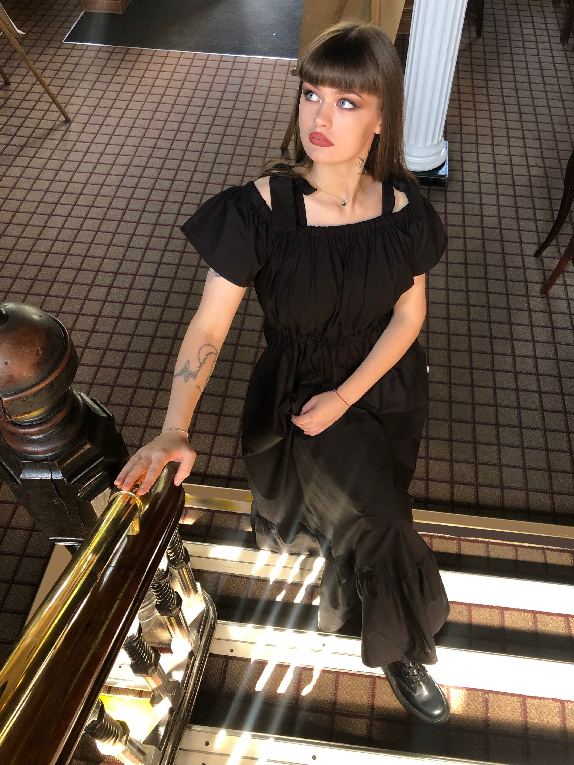 Pictured is the Midaxi Zwina Dress With Pockets in black on our model who is 5"11 and wears a small, with black boots