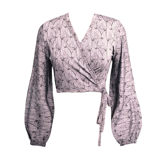 A pink and black geometric print wrap top with blouson sleeves and a tie waist.