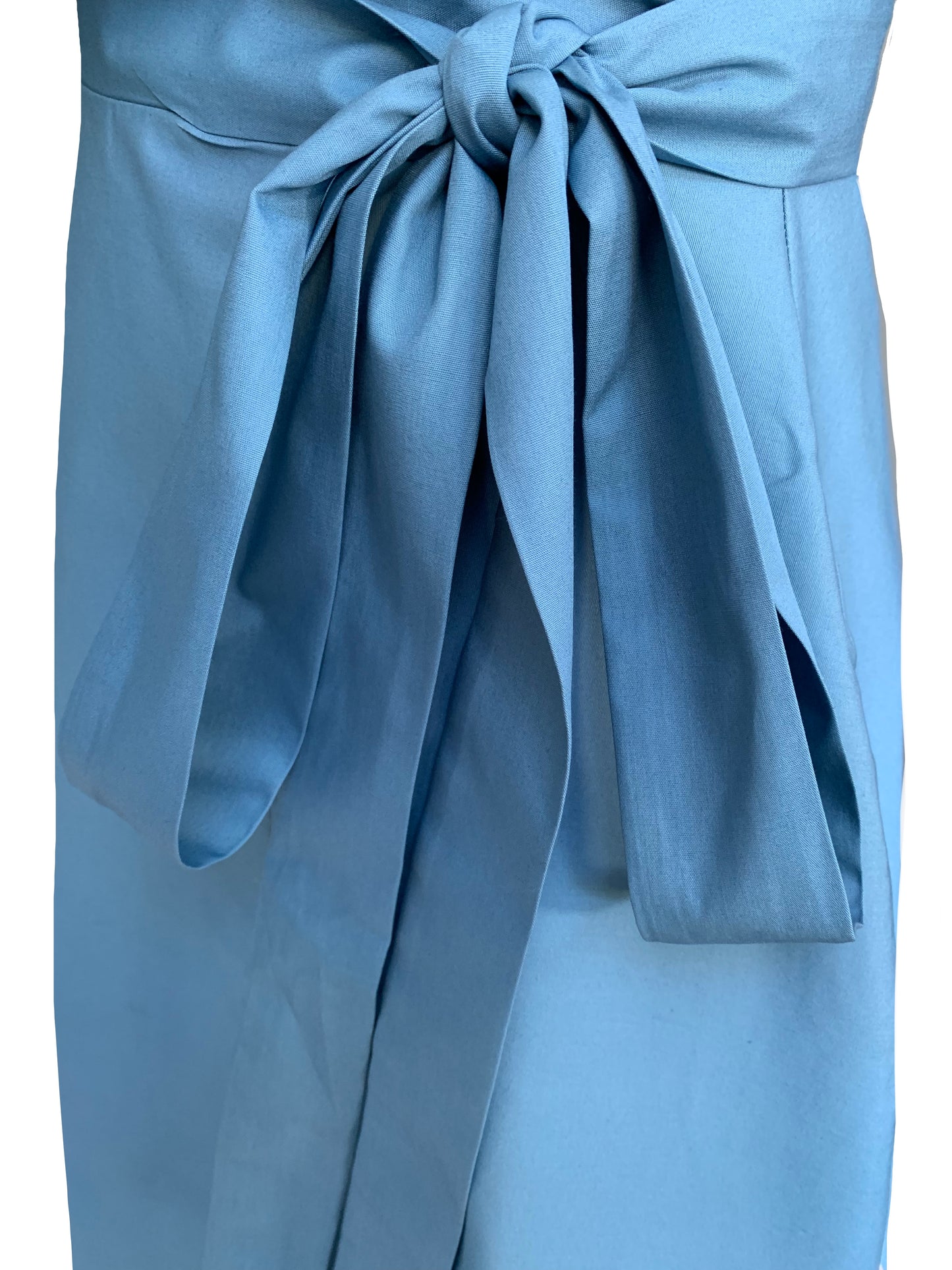 This is a Wedgewood blue functional wrap skirt with focus on the detailed tie. silhouetted against a white background with side seam pockets. The skirt is midi length and has a 4cm wide tie long enough to make a bow at the side of the waist.