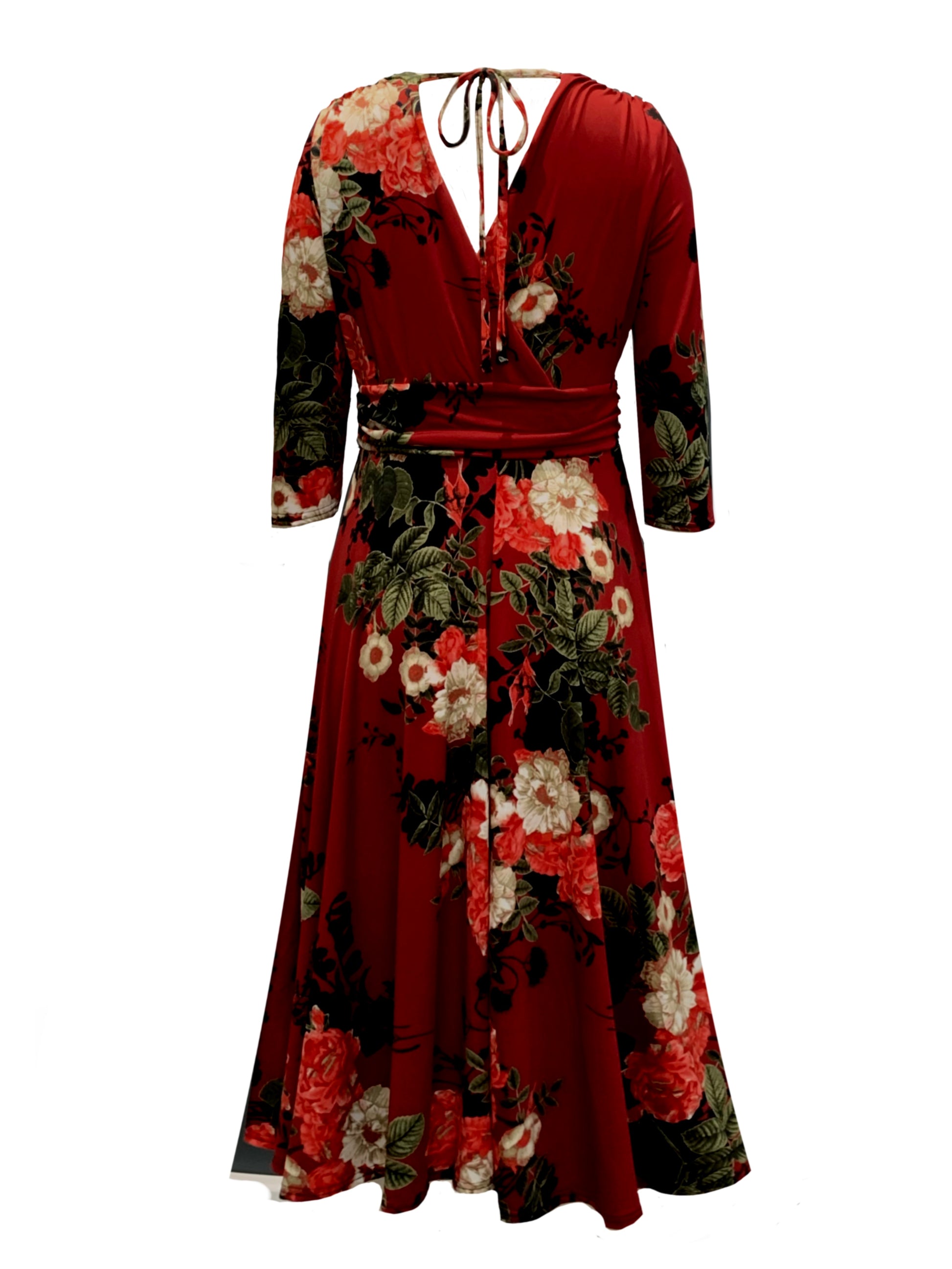 This is the back view of a Mock wrap midi dress in a Red floral design, with 3/4 length sleeves, a gathered shoulder and under bust area, with a tie, secured in a bow. It has a V shaped back, secured with a tie, in a bow. The dress has a midi length full skirt in a retro style, silhouetted on a white background.