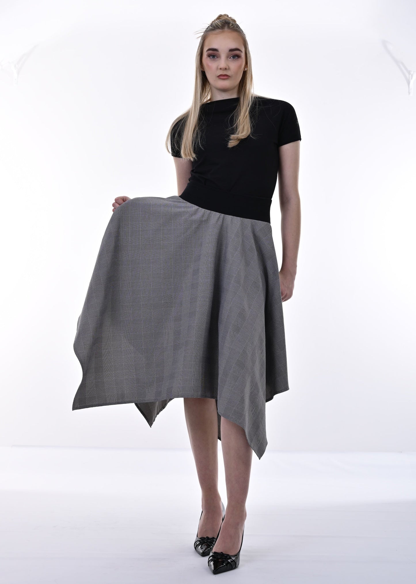 Woman holding a gray skirt on a white background