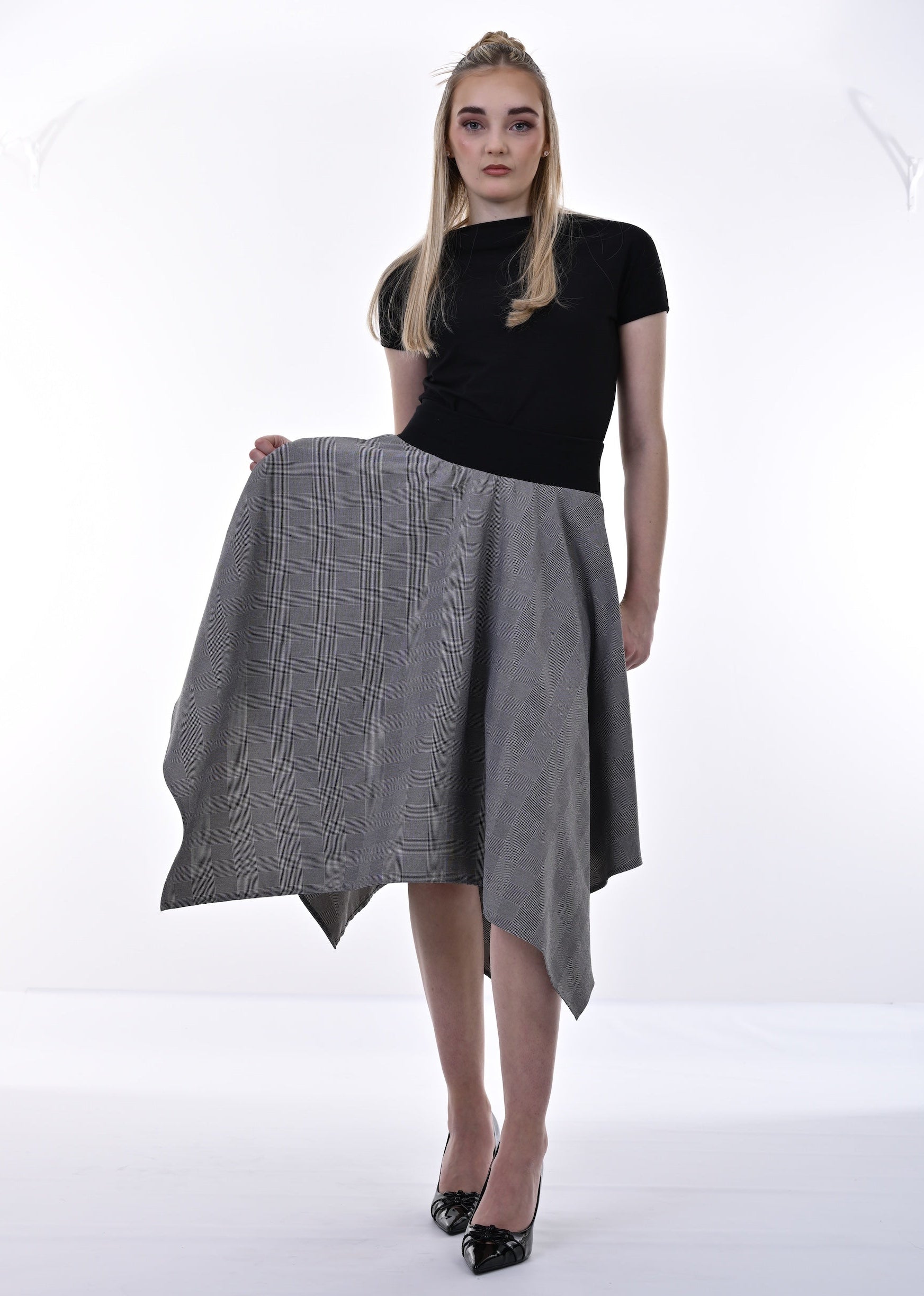 Woman holding a gray skirt on a white background