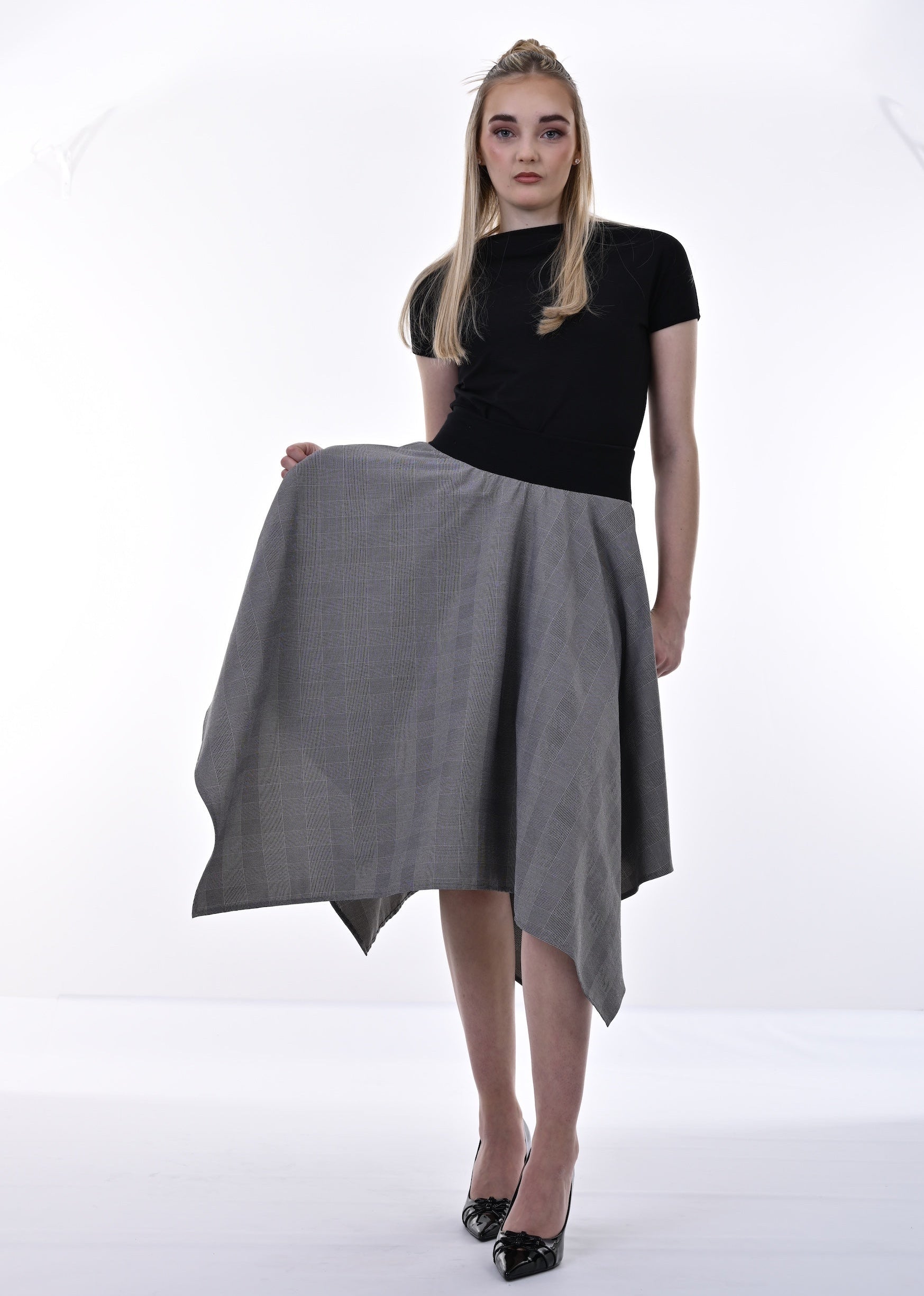 Woman holding a gray skirt on a white background