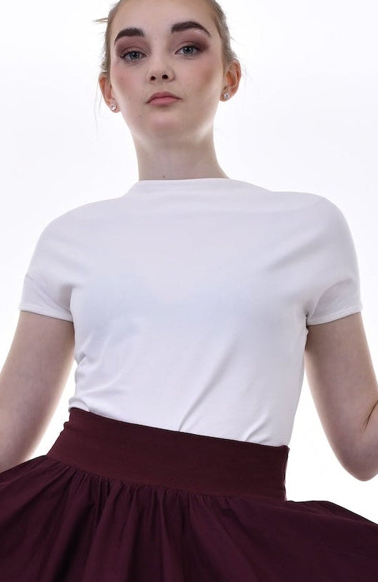Person wearing a white top and burgundy skirt on a white background