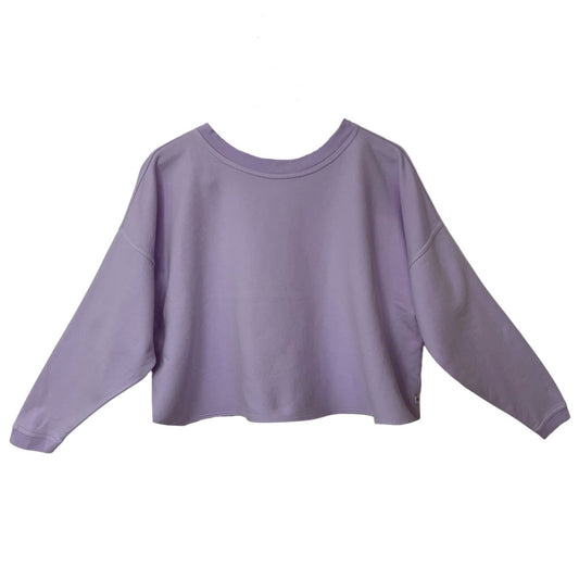 This a loose round neck sweatshirt in lilac silhouetted against a white background. The shoulders are dropped and the long sleeves end with a narrow rib at the cuff. the garment is cropped to the waist and has no band around the hem.