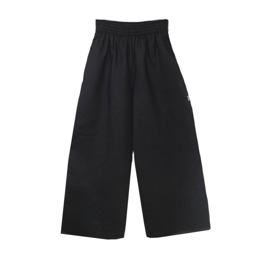 This is a picture of a black wide leg cropped trouser set against a white background. The trouser has side seam pockets and the waistband has several rows of elastic creating a ruched effect..